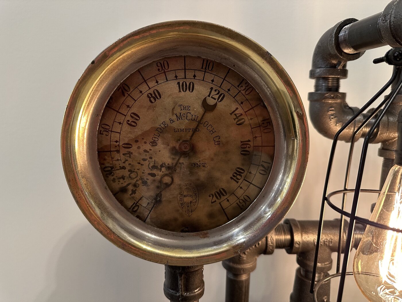 Close-up of the antique Goldie & McCulloch steam pressure gauge dial