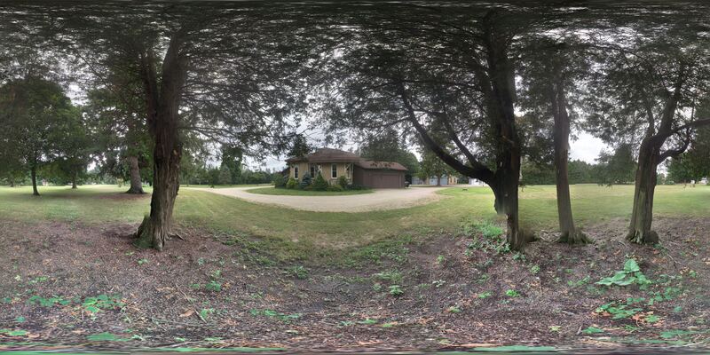 360° view of the grounds — the house seen across the lawn through mature trees